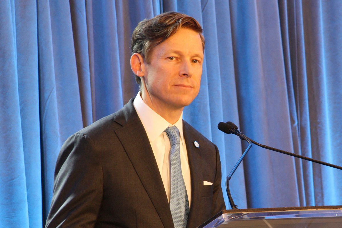 UNC-CH chancellor stands at a lectern