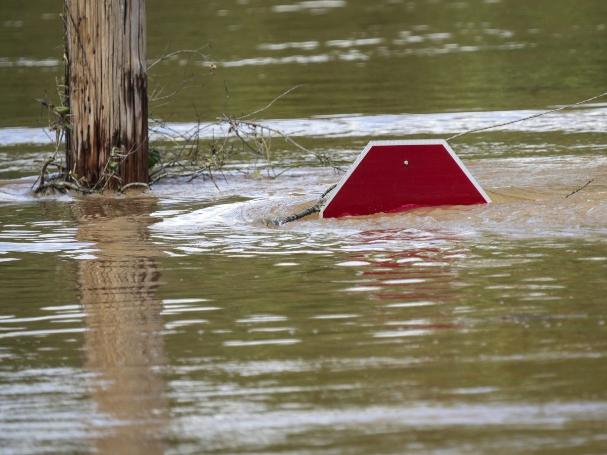 top of stop sign sticking out of storm waters from hurricane Helene