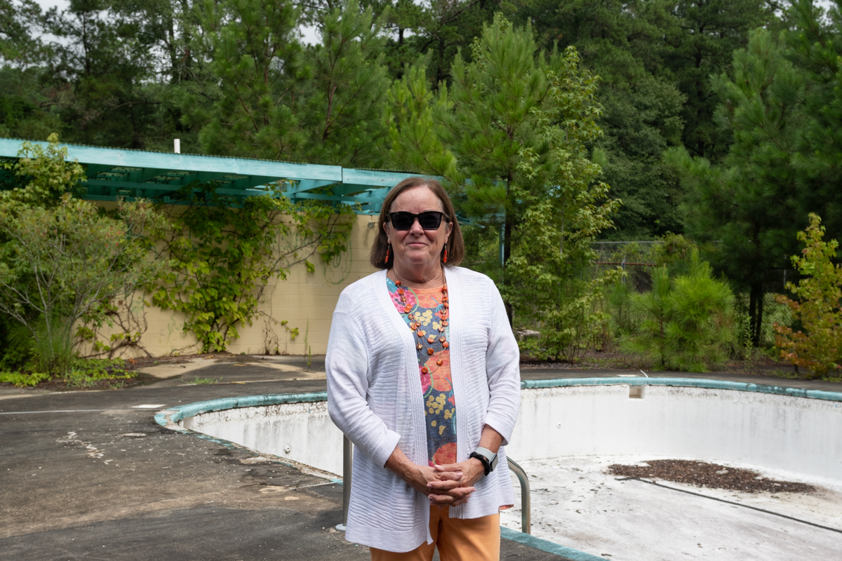 Lauren Cole stands in front of an empty pool