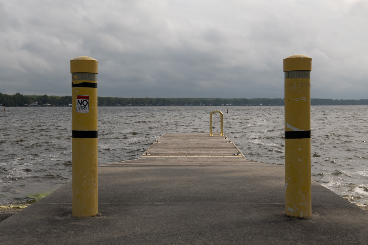 an empty dock leading to water