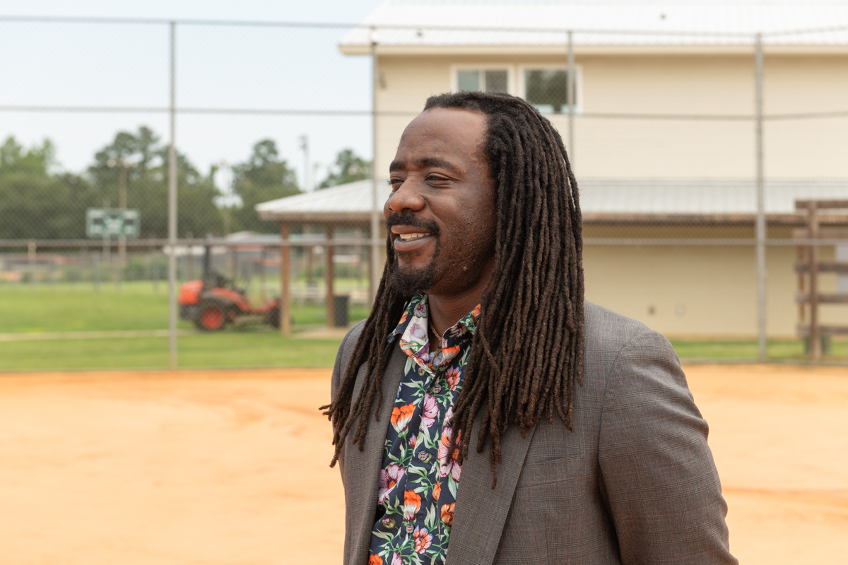 Shaq Davis stands on a baseball diamond