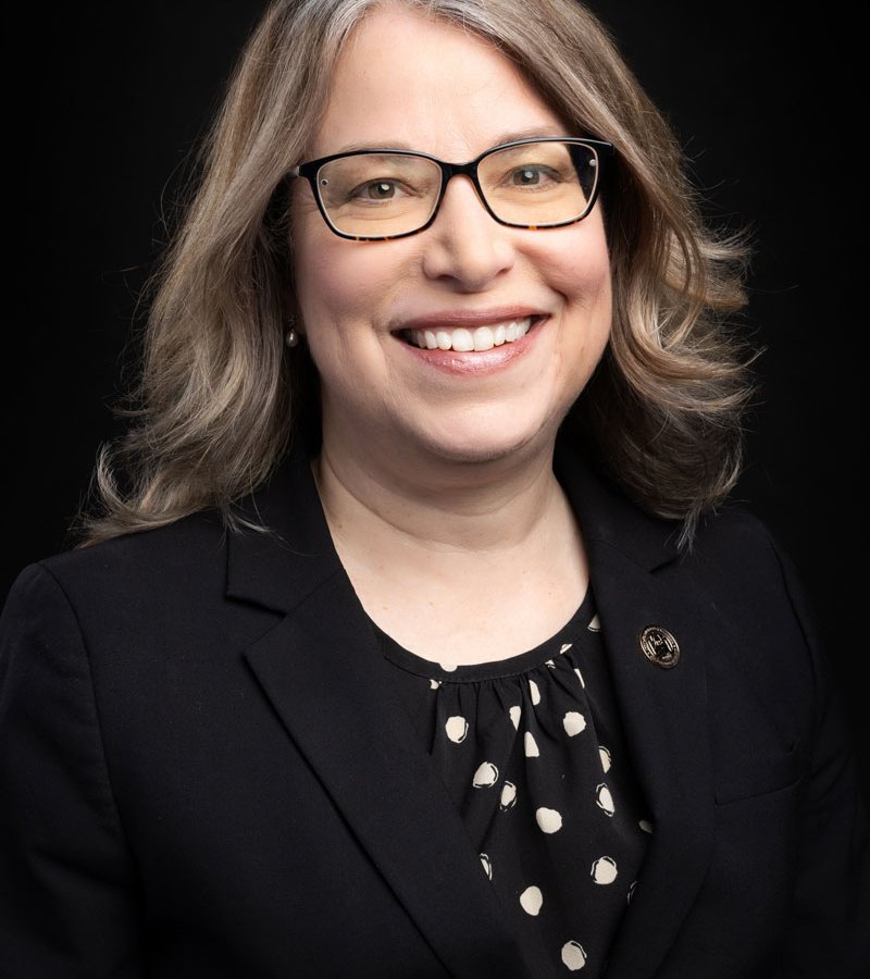 headshot of a woman in glasses